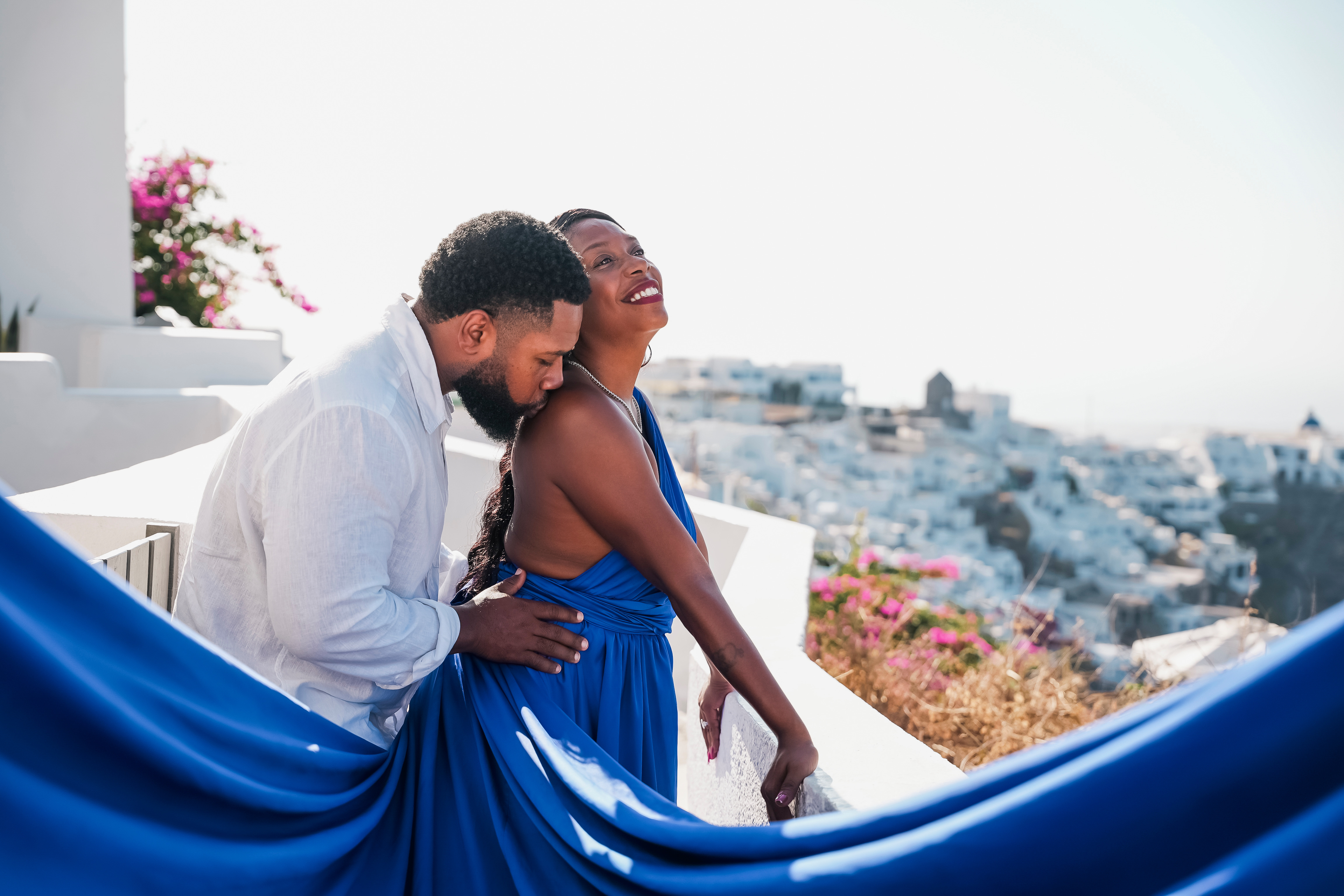 The Newkirks sharing a romantic moment overlooking Santorini